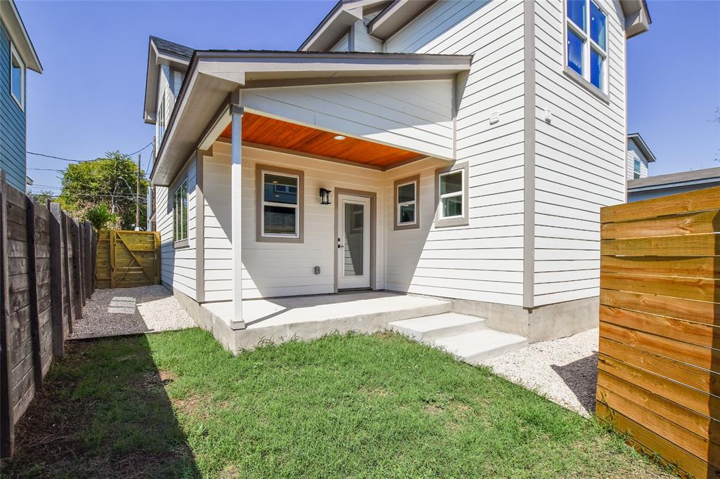 7103 Bennett Avenue, Unit 1 Austin, TX 78752 - Photo 24 of 25 a view of a house with a small yard and a garage