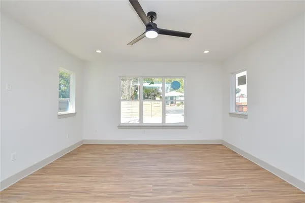 wooden floor in an empty room with a window