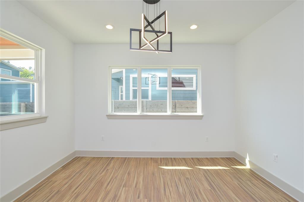 7103 Bennett Avenue, Unit 1 Austin, TX 78752 - Photo 7 of 25 a view of an empty room with wooden floor and a window
