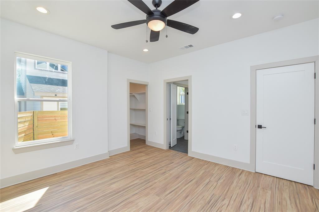 7103 Bennett Avenue, Unit 1 Austin, TX 78752 - Photo 10 of 25 a view of an empty room with window and wooden floor