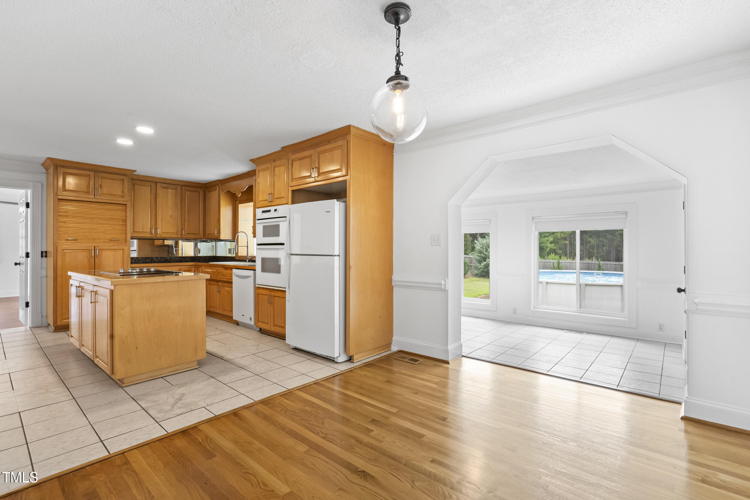 771 Brown Road Lillington, NC 27546 - Photo 14 of 37 a kitchen with granite countertop a refrigerator a stove top oven and a center island