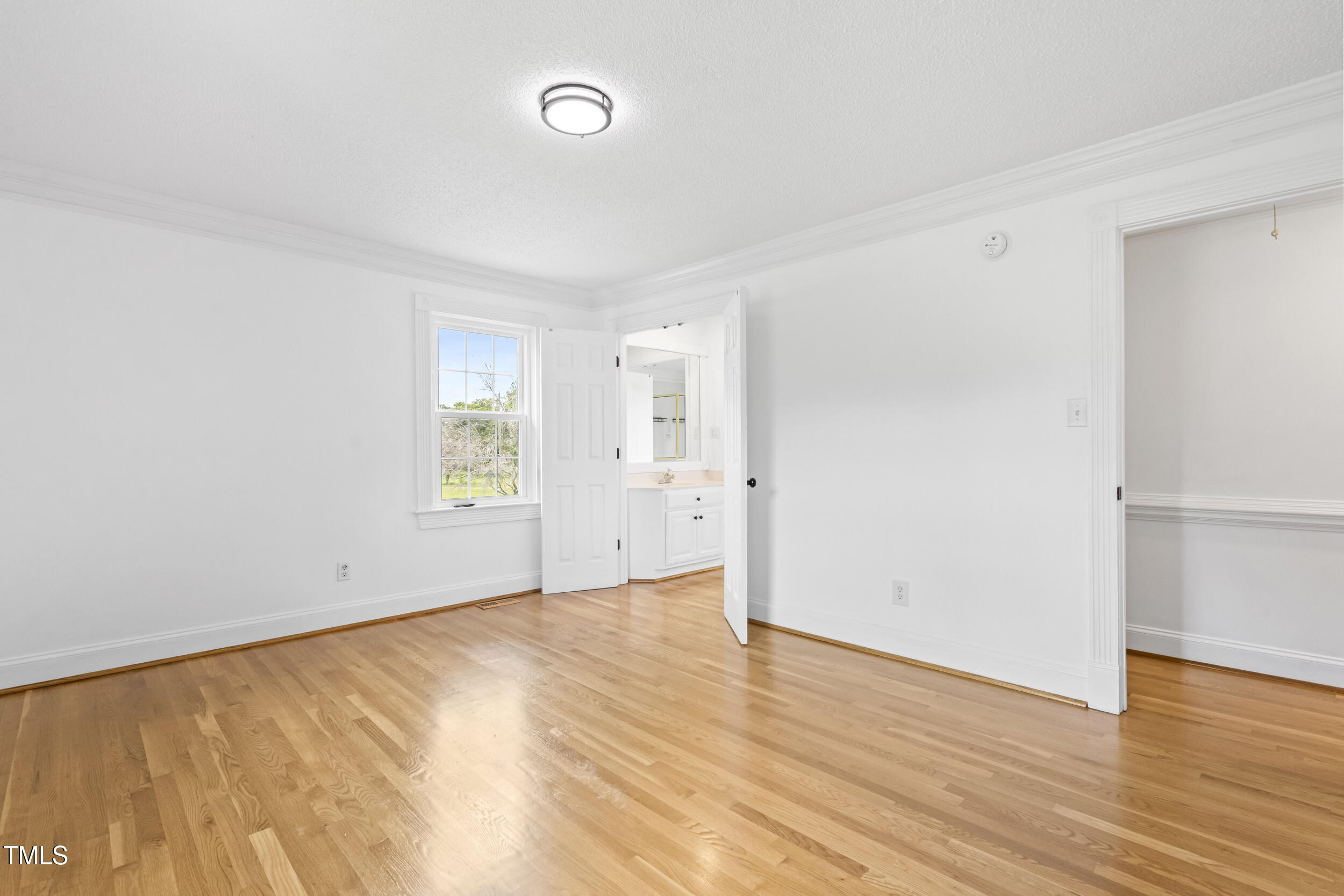 771 Brown Road Lillington, NC 27546 - Photo 17 of 37 an empty room with wooden floor and windows