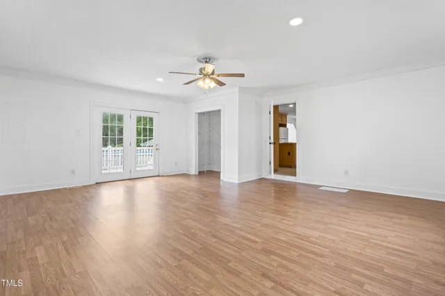 wooden floor in an empty room with a window
