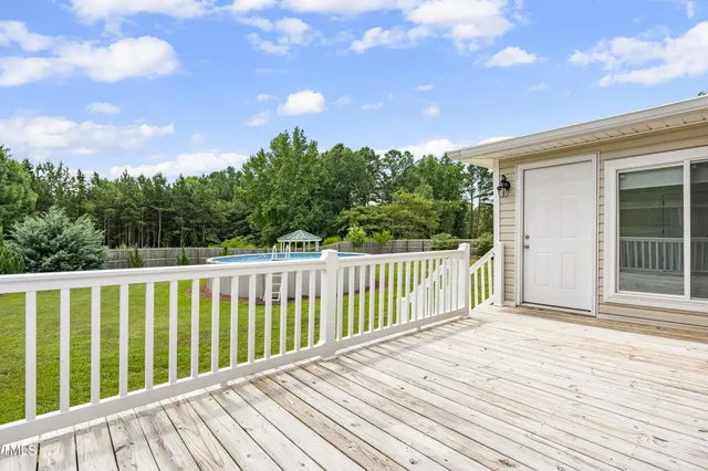 a balcony with wooden floor and fence