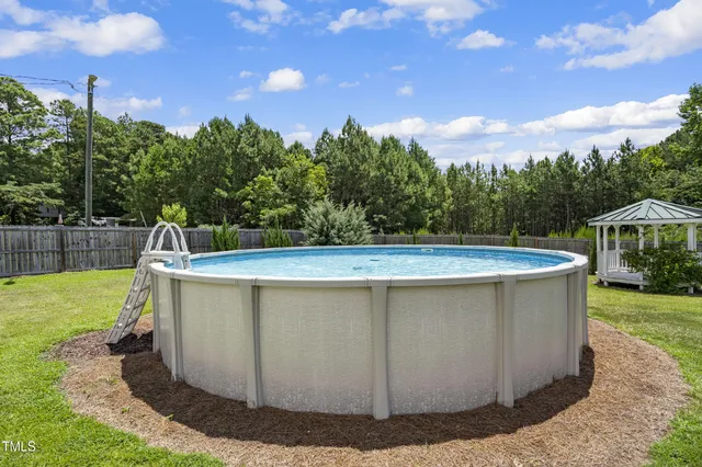 a view of a swimming pool with a yard