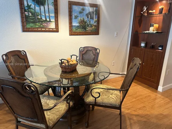 a living room with furniture dining room and a wooden floor