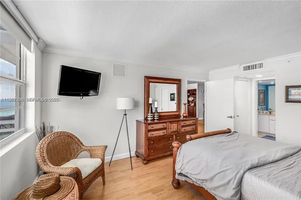 a bedroom with a bed and a chair