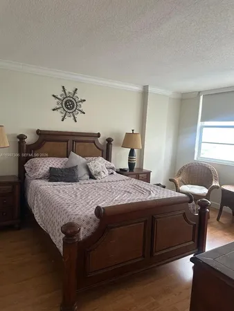 a bedroom with a bed and a potted plant