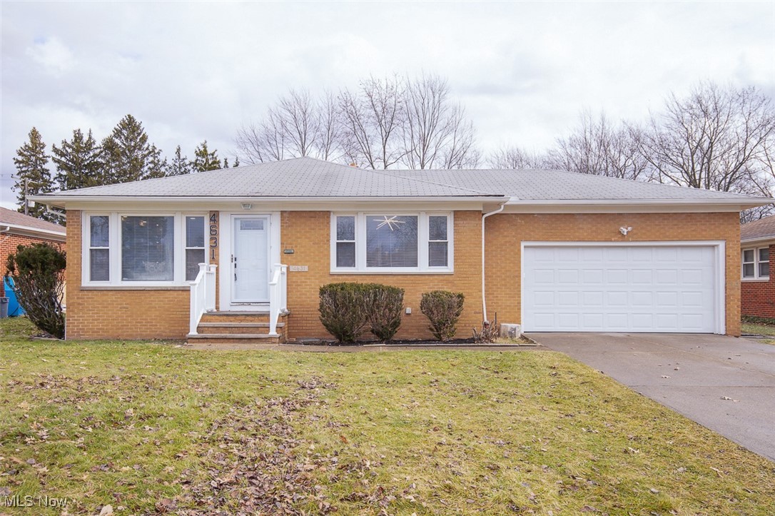 4631 Belfiore Road Cleveland, OH 44128 - Photo 26 of 28 Ranch-style home featuring concrete driveway, a front lawn, brick siding, and an attached garage