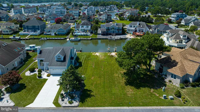an aerial view of residential houses with outdoor space and swimming pool