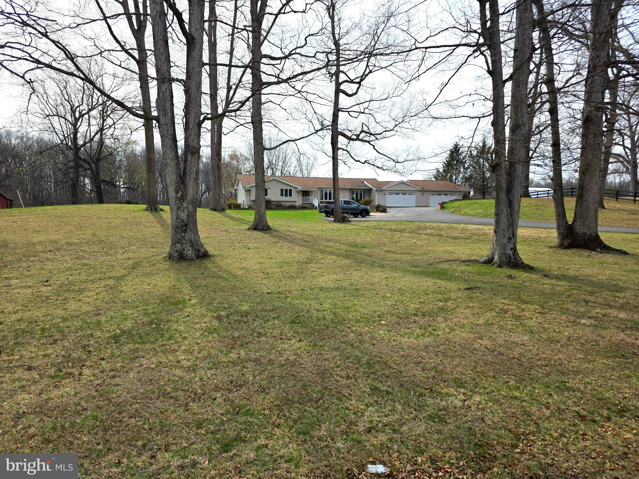 5639 Balls Mill Road Midland, VA 22728 - Photo 1 of 1 Spacious lawn framed by tall trees.