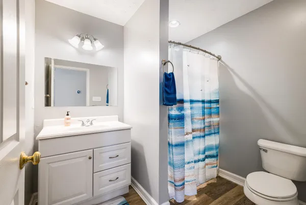 a spacious bedroom with a bed and a dresser