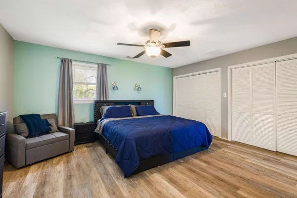 a bathroom with a double vanity sink a toilet and a shower
