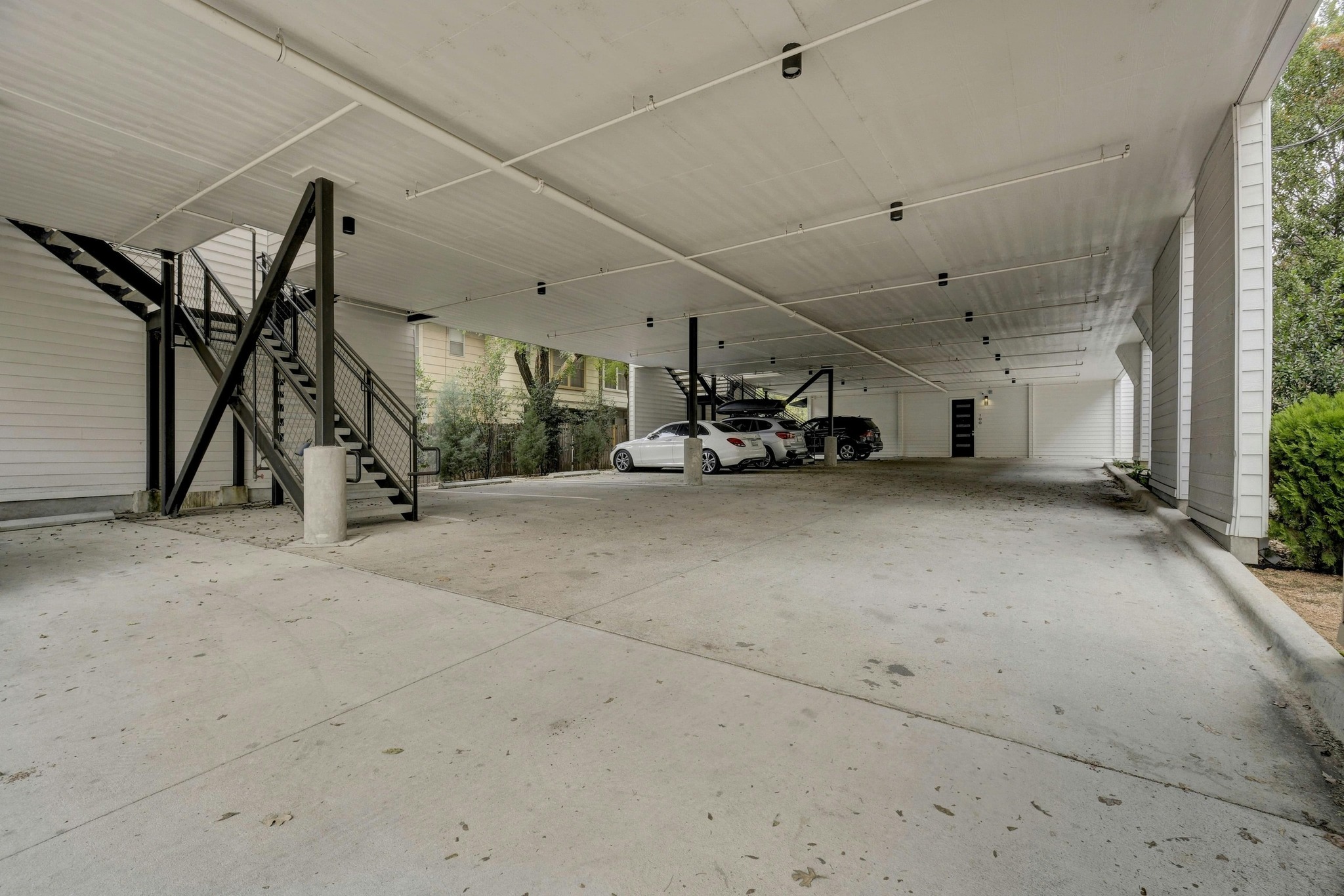 2314 Enfield Road, Unit 202 Austin, TX 78703 - Photo 19 of 20 Ample parking beneath a modern structure with accessible stairwells and easy entry.