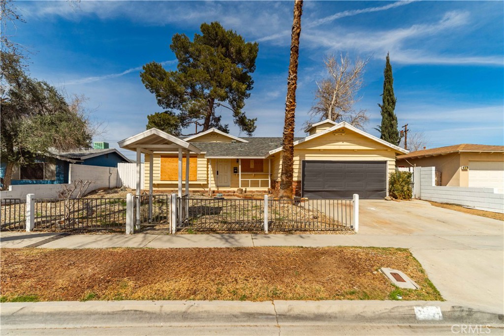621 East Ave. J Lancaster, CA 93535 - Photo 1 of 25 a front view of a house with garden