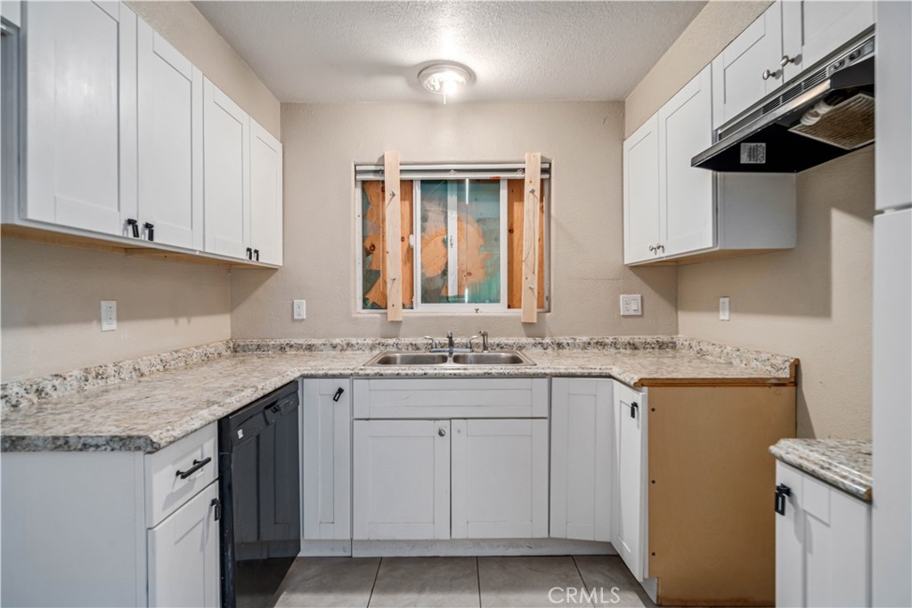 621 East Ave. J Lancaster, CA 93535 - Photo 11 of 25 a kitchen with a sink stove and cabinets