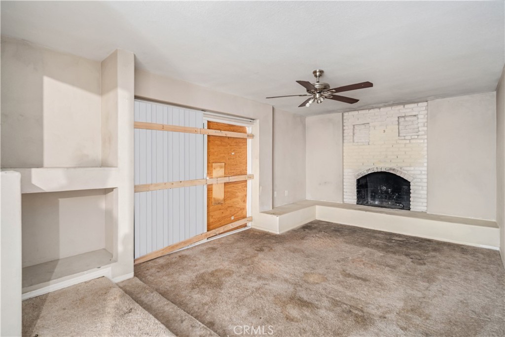 621 East Ave. J Lancaster, CA 93535 - Photo 13 of 25 an empty room with fireplace and windows