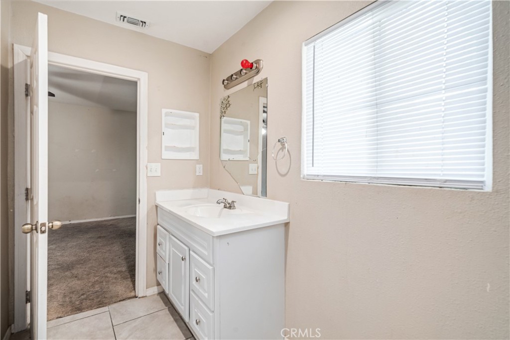 621 East Ave. J Lancaster, CA 93535 - Photo 18 of 25 a bathroom with a sink a vanity and a mirror