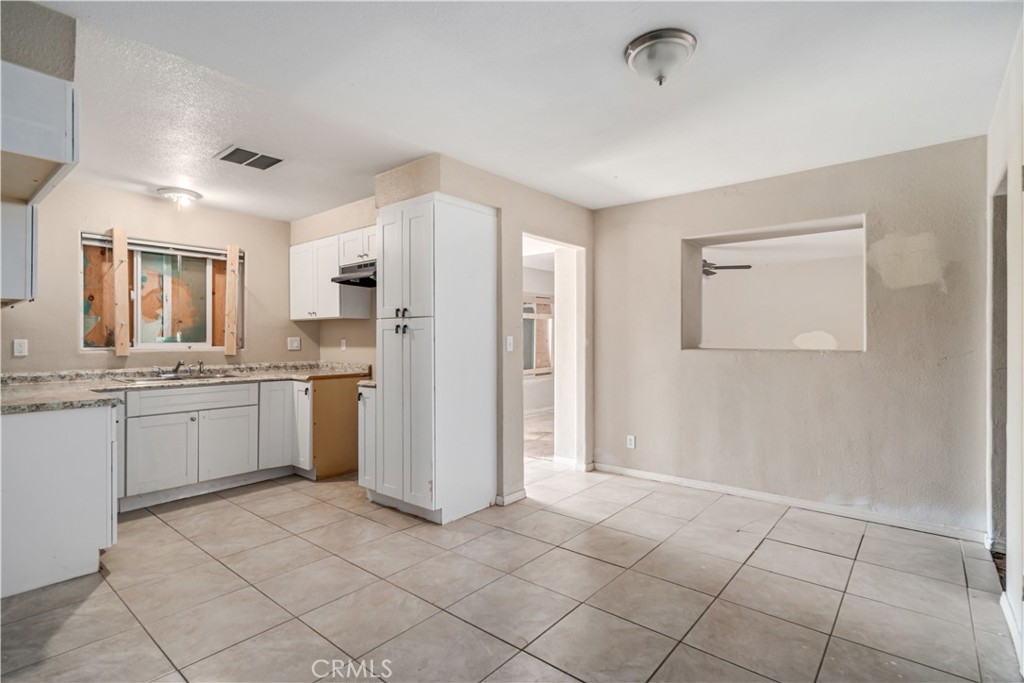 621 East Ave. J Lancaster, CA 93535 - Photo 10 of 25 a kitchen with a refrigerator sink and cabinets