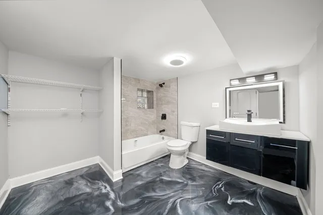 a spacious bathroom with a sink and a toilet