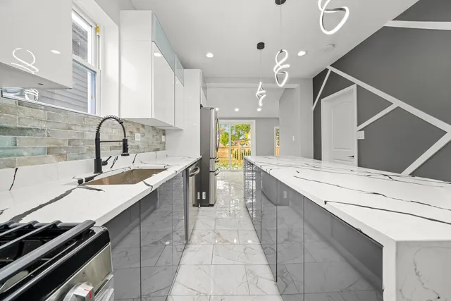 a kitchen with a sink stove and cabinets