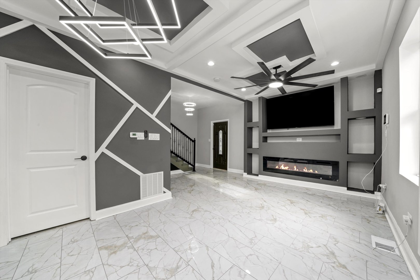 7918 South Anthony Avenue Chicago, IL 60619 - Photo 8 of 34 a view of an empty room with a fireplace and a chandelier