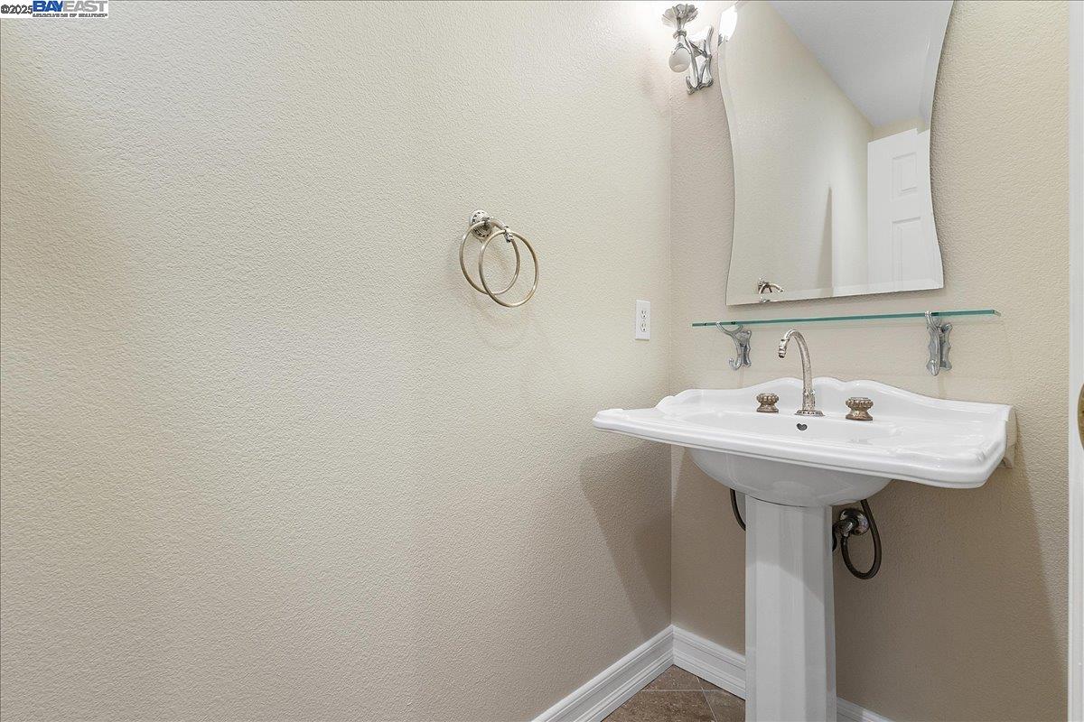 3 Cerruti Court Alameda, CA 94501 - Photo 11 of 22 a bathroom with a sink a mirror and vanity