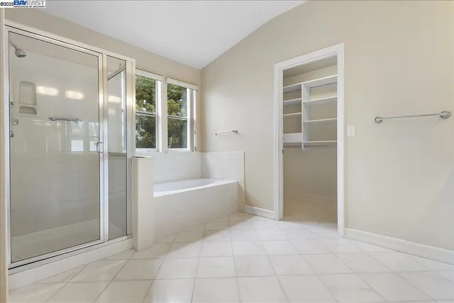 a bathroom with a tub shower and sink