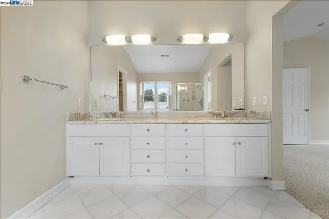 a bathroom with a granite countertop sink mirror and double