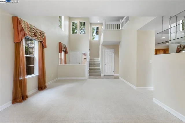 a view of a big room with closet and windows