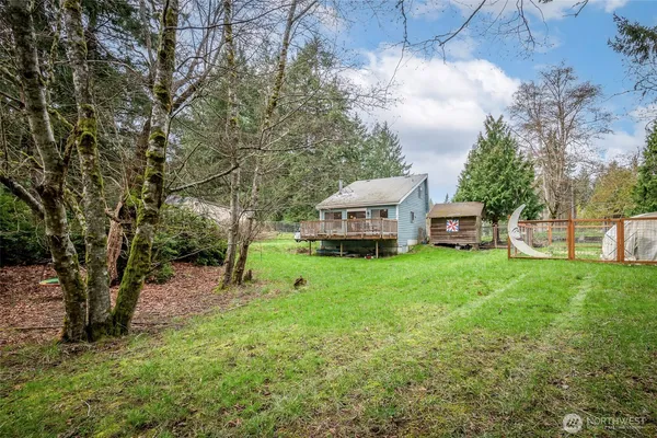 a view of a house with backyard sitting area and garden