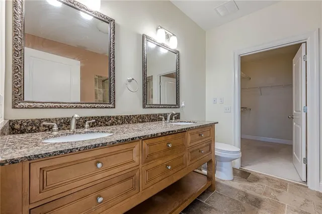 a bathroom with a granite countertop sink mirror and double