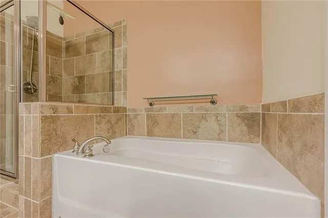 a bathroom with a bathtub and shower