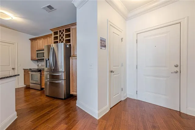 a view of a refrigerator in kitchen and wooden floor