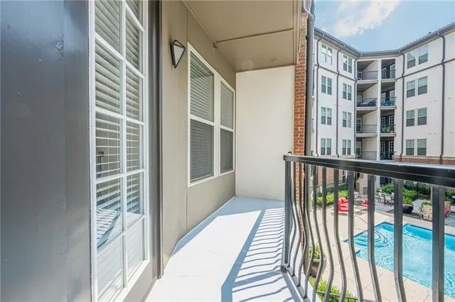 a view of a patio with dining table and chairs and potted plants