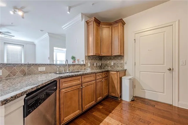 a kitchen with stainless steel appliances granite countertop a sink stove and cabinets