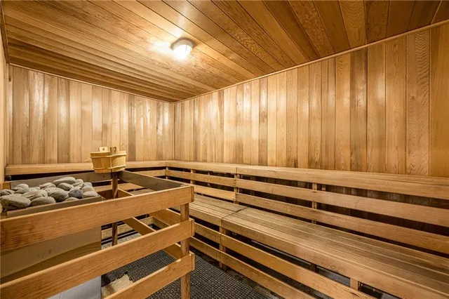 a view of swimming pool with red chairs in front of a house