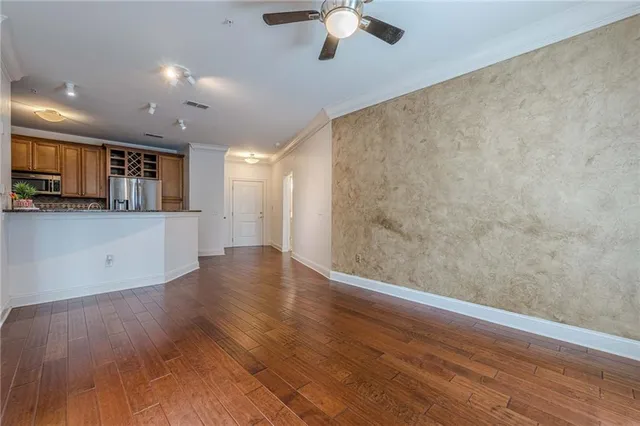 a view of a kitchen with a sink and dishwasher with wooden floor