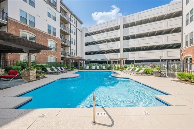 a swimming pool with outdoor seating and yard