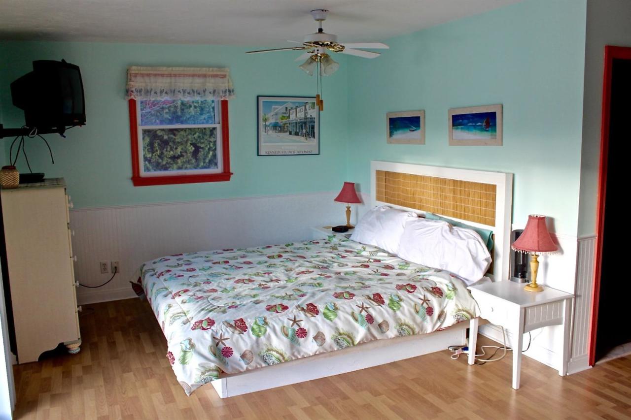 345 Monomoscoy Road Mashpee, MA 02649 - Photo 11 of 19 a bedroom with a bed and wooden floor