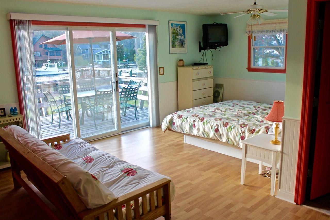 345 Monomoscoy Road Mashpee, MA 02649 - Photo 12 of 19 a bedroom with a bed and wooden floor