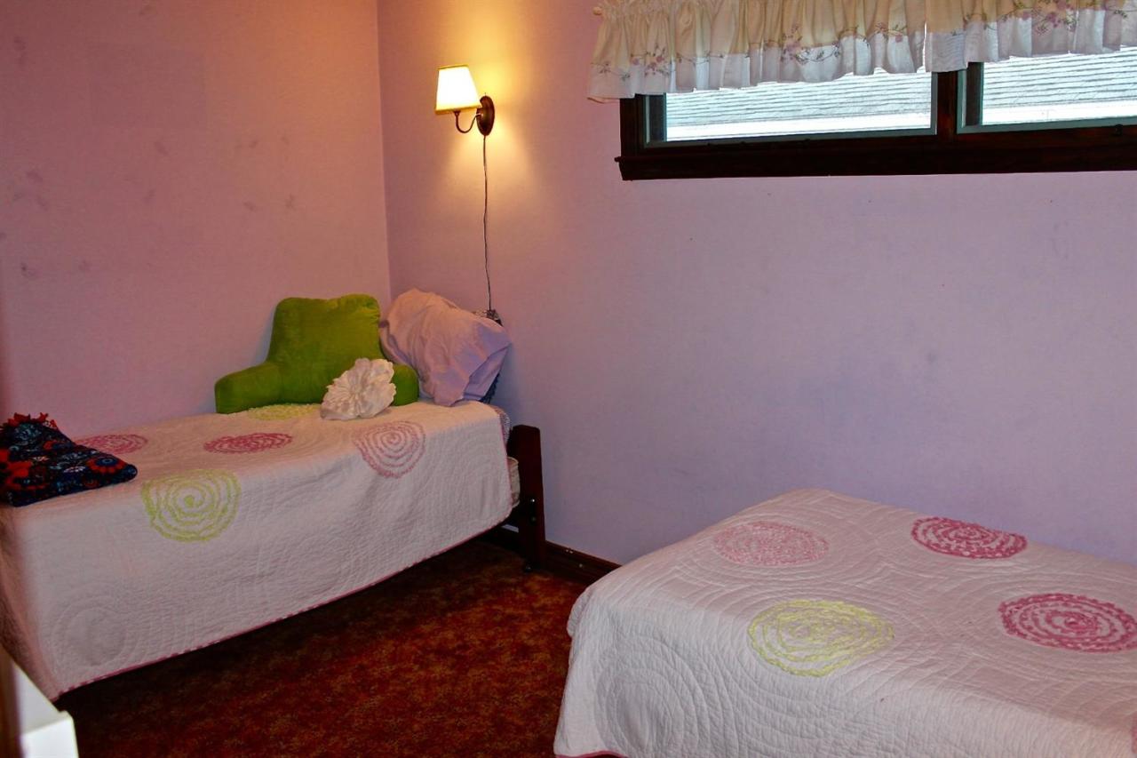 345 Monomoscoy Road Mashpee, MA 02649 - Photo 13 of 19 a bedroom with a bed and a potted plant