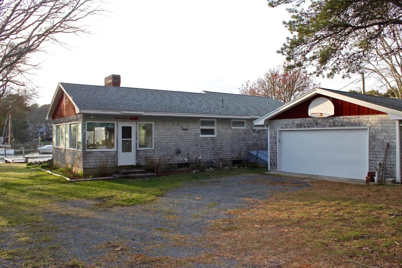 345 Monomoscoy Road Mashpee, MA 02649 - Photo 5 of 19 a front view of a house with a yard and garage