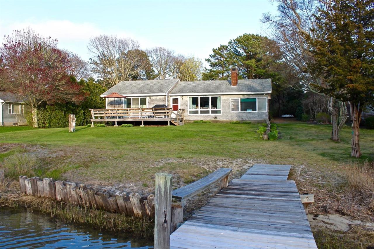 345 Monomoscoy Road Mashpee, MA 02649 - Photo 6 of 19 a front view of a house with a yard table and chairs