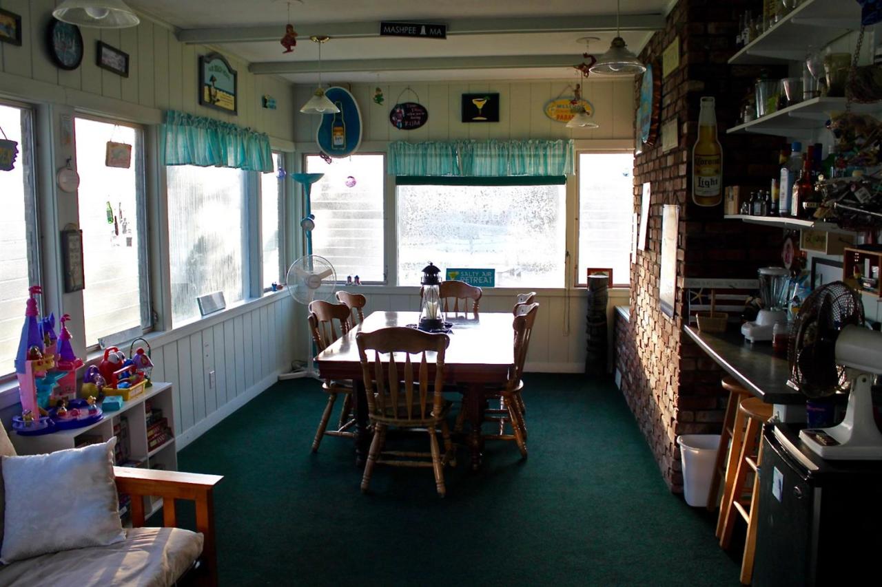 345 Monomoscoy Road Mashpee, MA 02649 - Photo 10 of 19 a dining room with furniture and a floor to ceiling window
