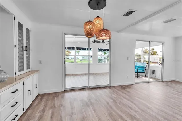 a view of a room with wooden floor and chandelier
