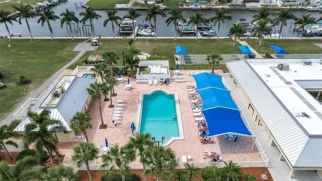 an aerial view of a house with a yard basket ball court and outdoor seating