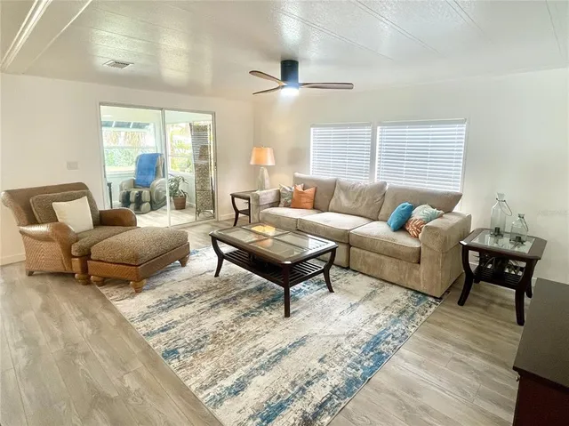 a living room with furniture lamp and a rug