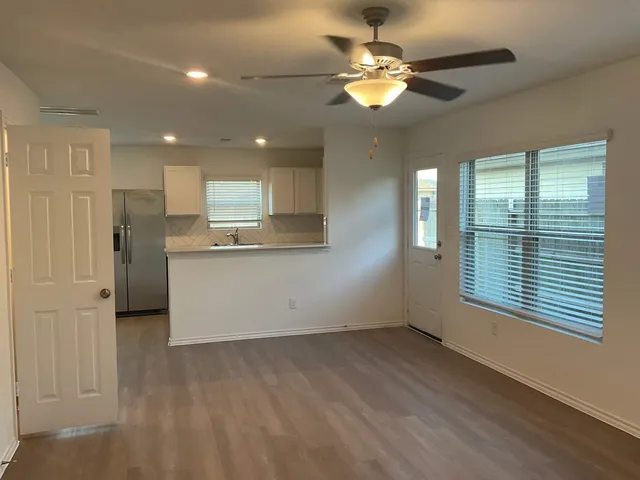 a view of a kitchen with a dishwasher cabinets and a large window