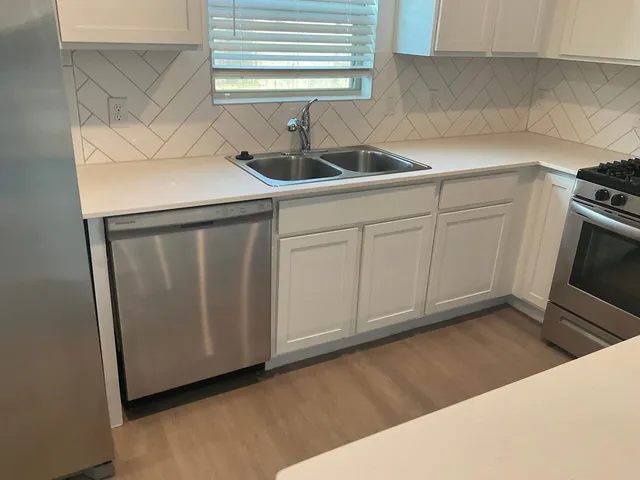 a kitchen with a sink and cabinets